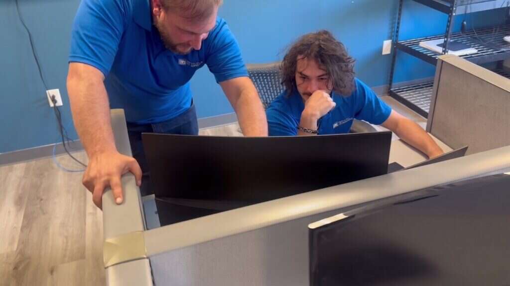 A senior Buffalo IT Services technician reviewing a client system with a team member