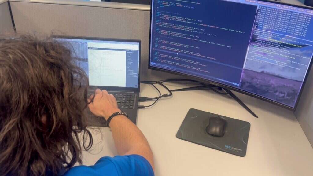 Buffalo IT Services network engineer reviewing live network diagnostics on dual monitors